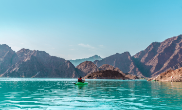 Turquoise mountain lake surrounded by rocky Hajar peaks